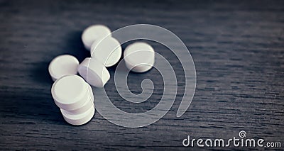 Multiple Round White Tablets Randomly left on a Table. Stock Photo