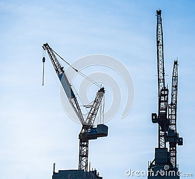 Multiple tower cranes above a concrete structure Stock Photo