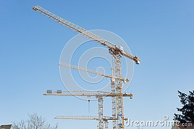 Multiple tower cranes at construction site Stock Photo