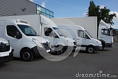 Multiple trucks park in a large parking Stock Photo