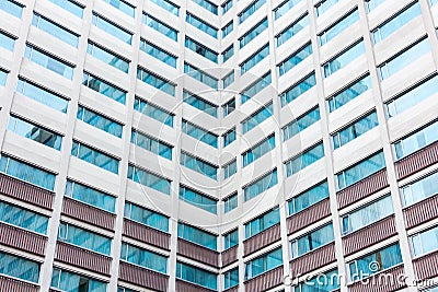 Multiple windows on a large office building Stock Photo