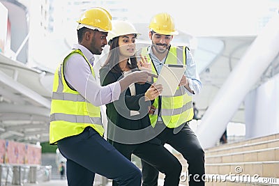 multiracial business engineers or architects team talking discussing online by tablet outside building Stock Photo