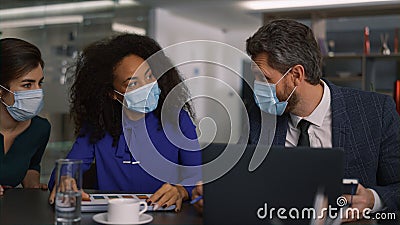 Diverse business team brainstorm together wearing protective face mask in office Stock Photo