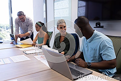 Multiracial businesswomen and businessmen planning strategy during meeting boardroom at workplace Stock Photo