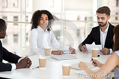 Multiracial colleagues negotiate during briefing in office Stock Photo
