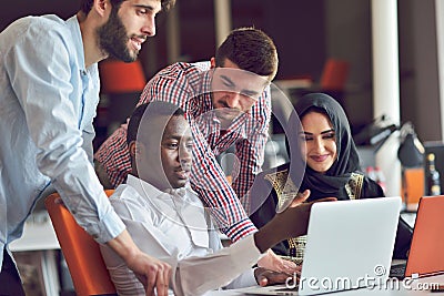 Multiracial contemporary business people working connected with technological devices like tablet and laptop Stock Photo