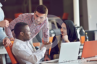 Multiracial contemporary business people working connected with technological devices like tablet and laptop Stock Photo