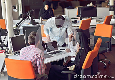 Multiracial contemporary business people working connected with technological devices like tablet and laptop Stock Photo