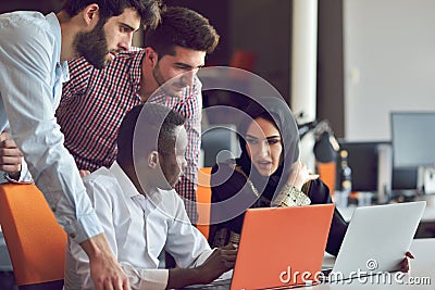 Multiracial contemporary business people working connected with technological devices like tablet and laptop Stock Photo