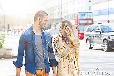 Multiracial couple walking in London Stock Photo