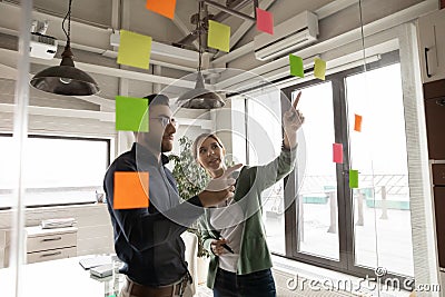 Multiracial employees engaged in creative thinking in office Stock Photo