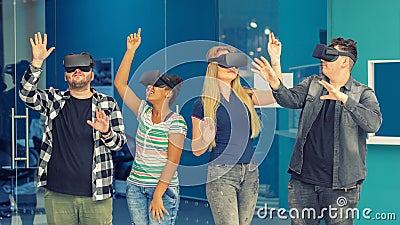 Multiracial friends group playing on vr glasses indoors. Virtual reality concept with young people having fun together. Stock Photo