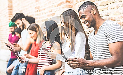 Multiracial friends group using smartphone at university college break - Millenial people addicted by mobile smart phones Stock Photo