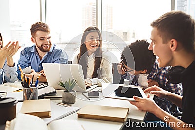 Multiracial friends studying at campus library together Stock Photo