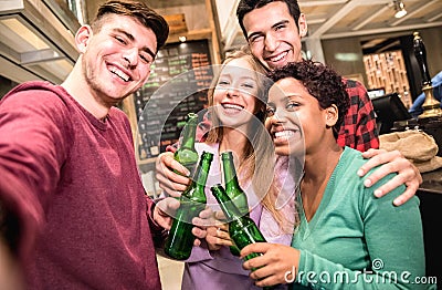 Multiracial friends taking selfie and drinking beer at fancy brewery pub Stock Photo