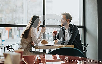 Multiracial friends talking over coffee Stock Photo