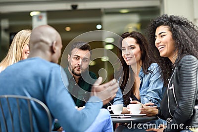 Multiracial group of five friends having a coffee together Stock Photo