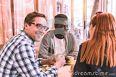 Multiracial group of friend in a coffee bar Stock Photo