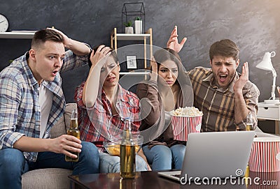Multiracial group of upset friends watching film Stock Photo