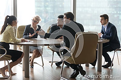 Multiracial team group disputing in office boardroom at meeting Stock Photo