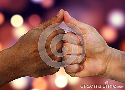 Multiracial hands together African American and Caucasian touching thumbs as team in promise sign of mutual trust representing Stock Photo
