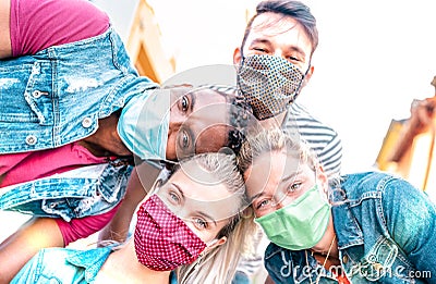 Multiracial millenial friends taking selfie smiling behind face masks - Happy friendship and new normal concept with young people Stock Photo