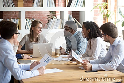 Multiracial colleagues brainstorm during company meeting in offi Stock Photo