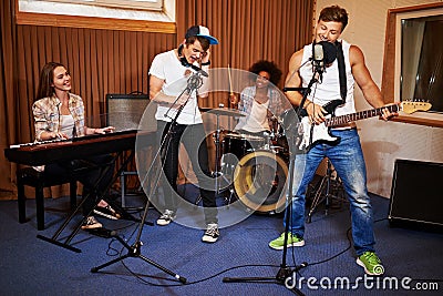 Multiracial music band performing in a recording studio Stock Photo