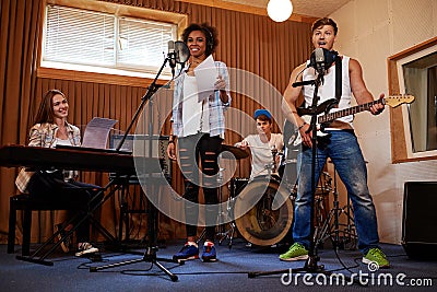 Multiracial music band performing in a recording studio Stock Photo