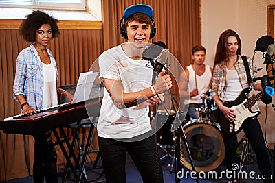 Multiracial music band performing in a recording studio Stock Photo