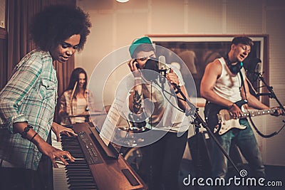 Multiracial music band in a studio Stock Photo