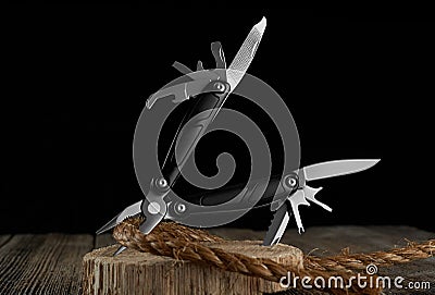 Multitool knife and rope on a dark background Stock Photo