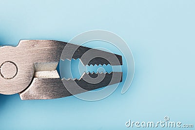 The multitool multi-function tool hovers on a blue background. The concept of an expanded multi-tool with free space Stock Photo