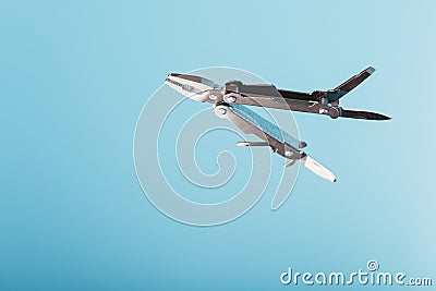 The multitool multi-function tool hovers on a blue background. The concept of an expanded multi-tool with free space Stock Photo