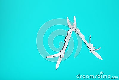 The multitool multi-function tool hovers on a blue background. The concept of an expanded multi-tool with free space Stock Photo