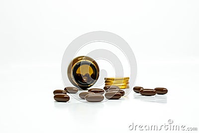 Multivitamin brown softgel capsules with white background with container and cap Stock Photo