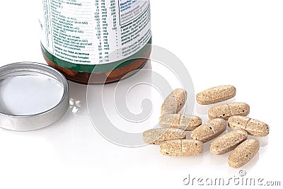 Multivitamins next to the open bottle Stock Photo