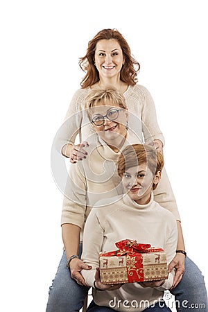 Mum at age with adult daughters smiling and hugging Stock Photo