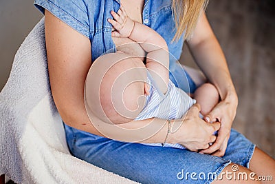 Mum is breastfeeding a child. Stock Photo
