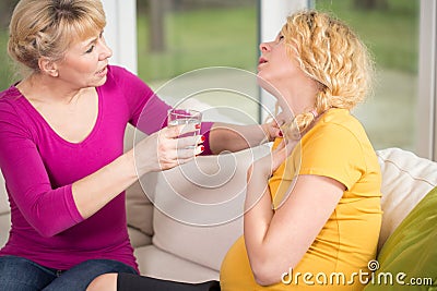 Mum caring about pregnant daughter Stock Photo