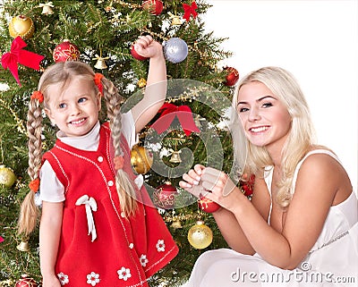 Mum with a daughter decorate christmas tree. Stock Photo