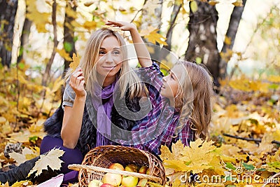 Mum and the daughter play autumn park Stock Photo