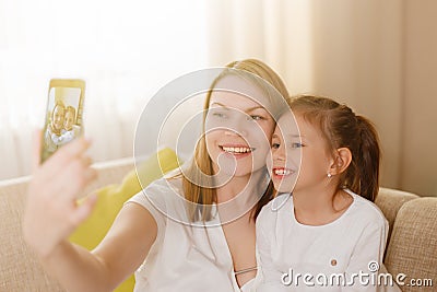Mum and her cute daughter child girl are playing, smiling and hugging. Happy mother& x27;s day. Stock Photo