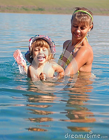 Mum learns to float the child Stock Photo