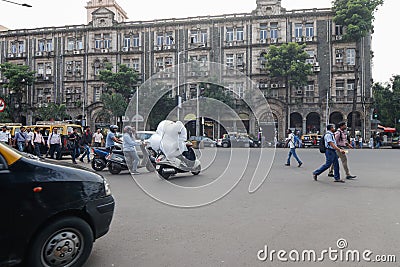 Mumbai,India,August-16-2019:Pedestrians recklessly jay walking on roads igboring running vehicular traffic Editorial Stock Photo