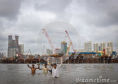 Children venturing dangerously in haji ali sea waters during high tides risking their lives Editorial Stock Photo