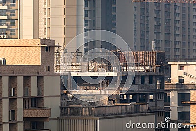 A building under construction in a dense, high rise residential neighbourhood in the Editorial Stock Photo