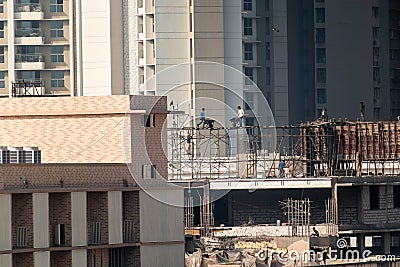 Mumbai, Maharashtra, India - January 2021: A building under construction in a dense, high rise residential neighbourhood in the Editorial Stock Photo
