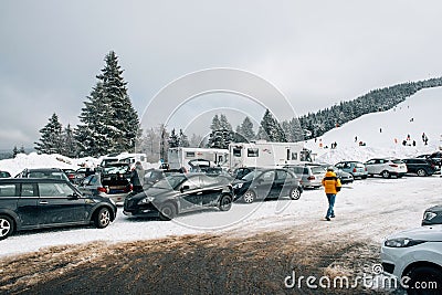 Winter day with snow and ski slope seen from parking area with k Editorial Stock Photo