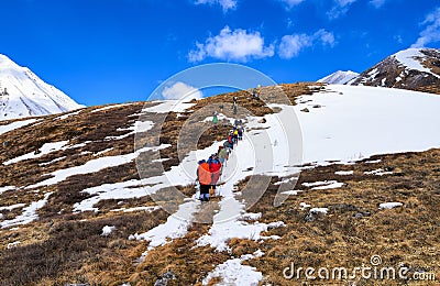 MUNCH-SARDYK, BURYATIA, RUSSIA - April 30.2016: Climbers on hillside in front of approach to foot of mountain Editorial Stock Photo